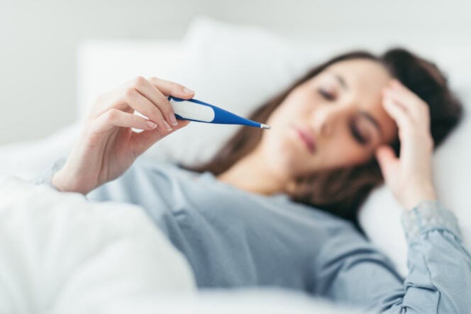 Woman measuring her temperature